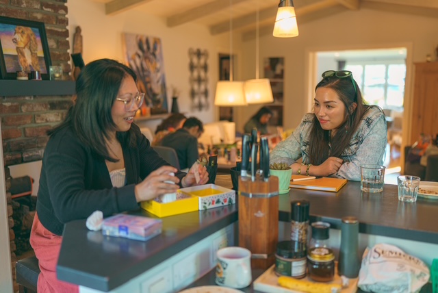 Friends sharing a meal at a kitchen counter